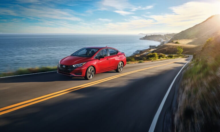 2024 Nissan Versa driving by coast