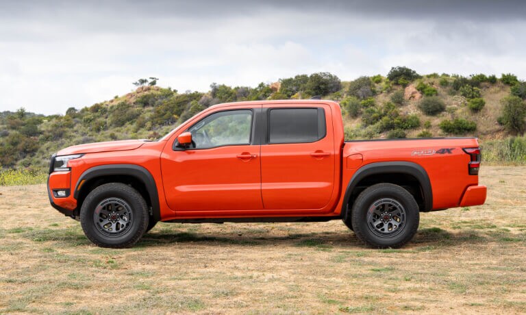 2025 Nissan Frontier side view in grassy field