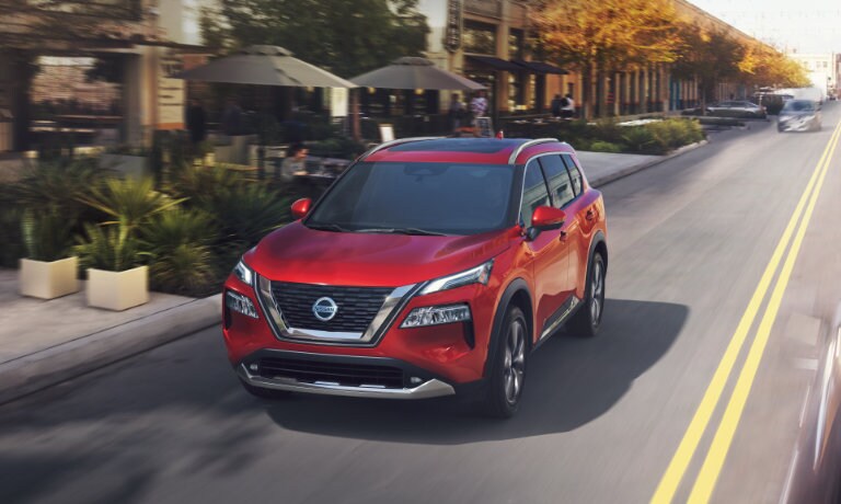 2022 Nissan Rogue driving down a city road