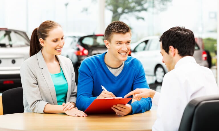 Couple making deal with salesman