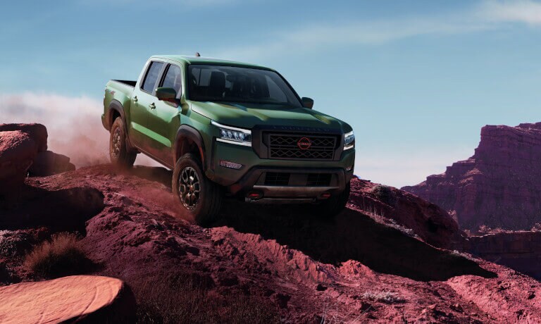2023 Nissan Frontier driving in rocky red desert