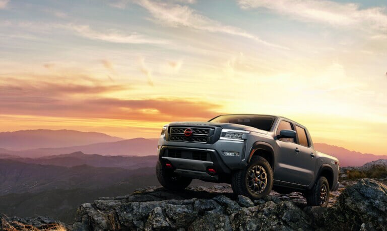 2022 Nissan Frontier parked on top of a mountain at sunset