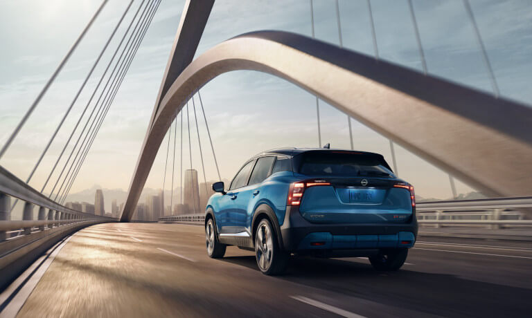2026 Nissan Kicks driving on a bridge