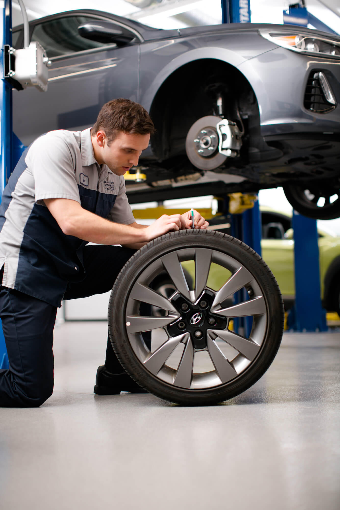 Hyundai of Central Florida - Service Technician Inspecting Tire