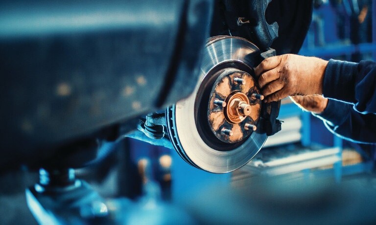 Mechanic fixing brakes Car service