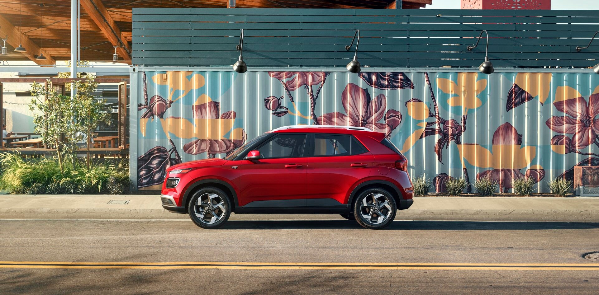 2020 Hyundai Venue red by flower graffiti on road.jpg
