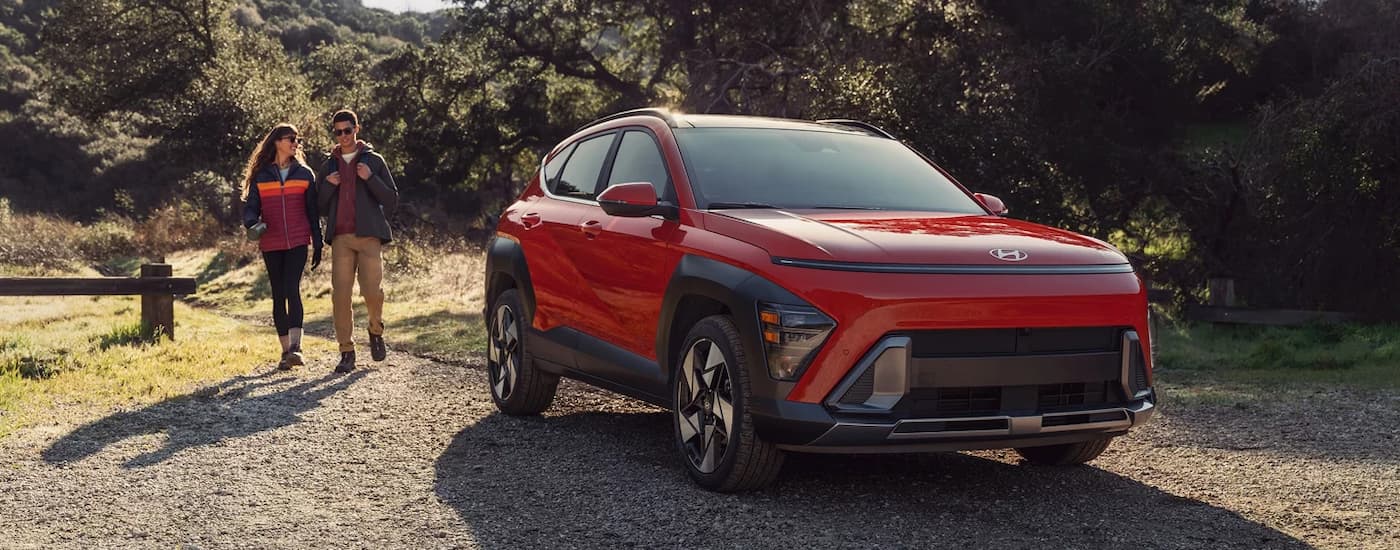 Red 2025 Hyundai Kona for sale near Stallings parked off-road.