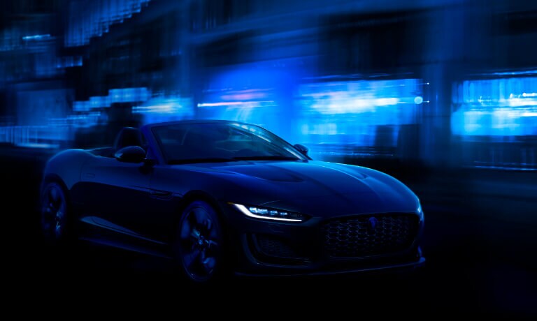 2024 Jaguar F-TYPE driving in blue light