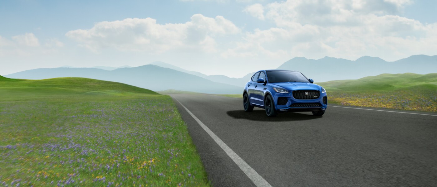 Blue 2021 Jaguar E-PACE exterior view driving