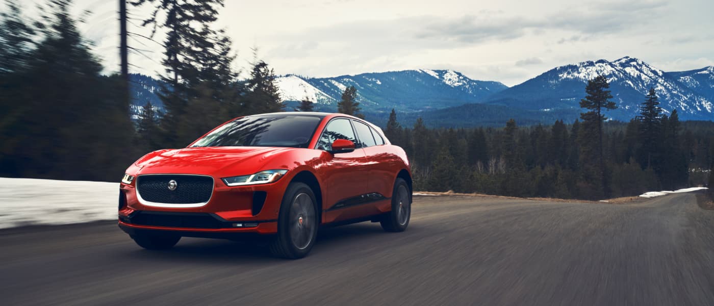 2020 Jaguar I-PACE driving on road with mountain in background