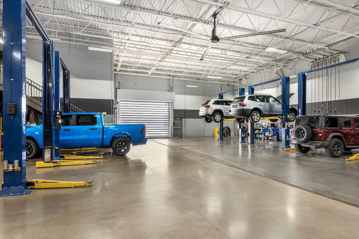 Vehicle service bays and lifts inside the Indy CDJR service facility in Brownsburg, Indiana