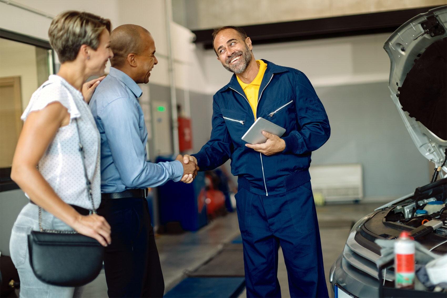Hyundai Certified Technician shaking hands with man after servicing vehicle