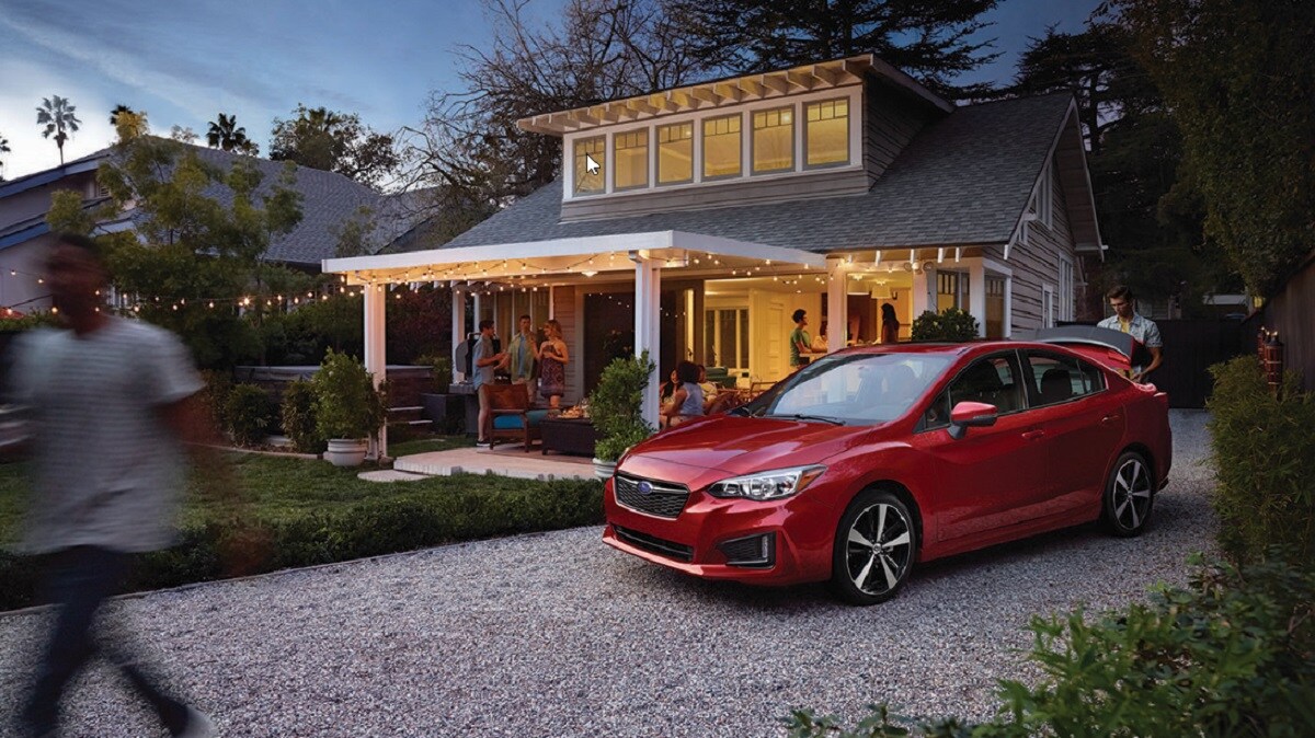 Front Right Side view Red 2018 Subaru Impreza in front of house party