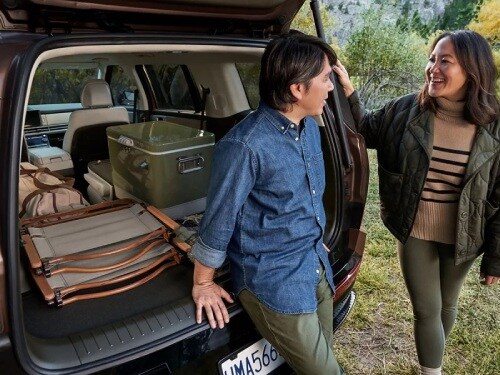 2025 Hyundai Santa Fe view of
man and woman standing at back of vehicle with liftgate open