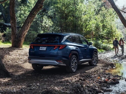2026 Hyundai TUCSON parked in a wooded area next to a creek