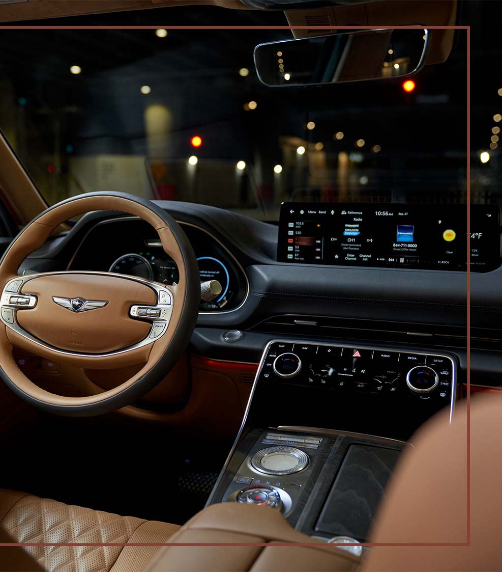 Compare the 2021 Genesis GV80 vs. the 2021 Audi Q7 at Genesis of York | Tan & Black Interior of the 2021 Genesis GV80 at Night - Showing off Steering Wheel & Dashboard and Center Console Technologies