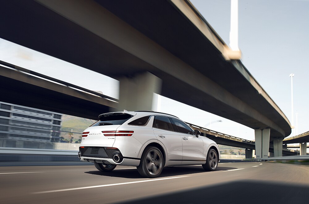 Leasing versus Buying a Genesis at Genesis of York in York, PA | 2022 Genesis GV70 driving away onto the highway