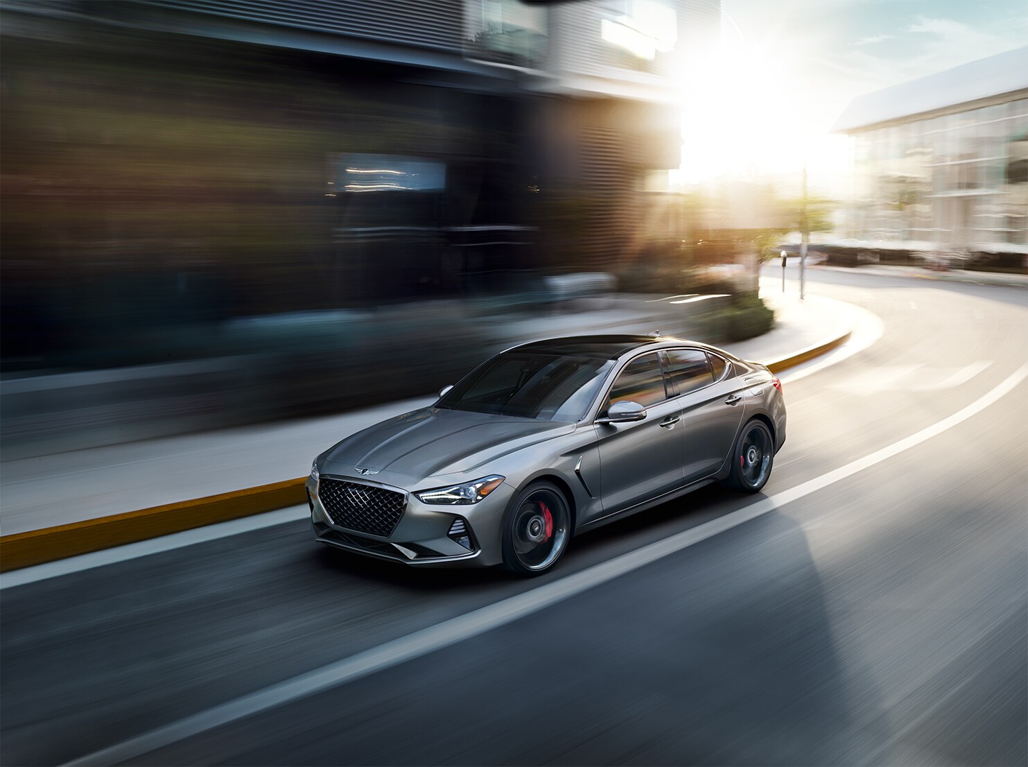 Genesis of York is a Jack Giambalvo Car Dealership in Hallam, PA | 2020 Genesis G70 driving in city