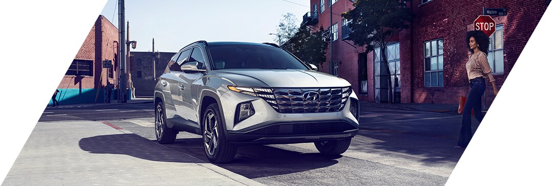 The 2022 Hyundai Tucson vs. The 2022 Hyundai Santa Fe at Jack Giambalvo Hyundai | Owner walks to Tucson that is parked in city