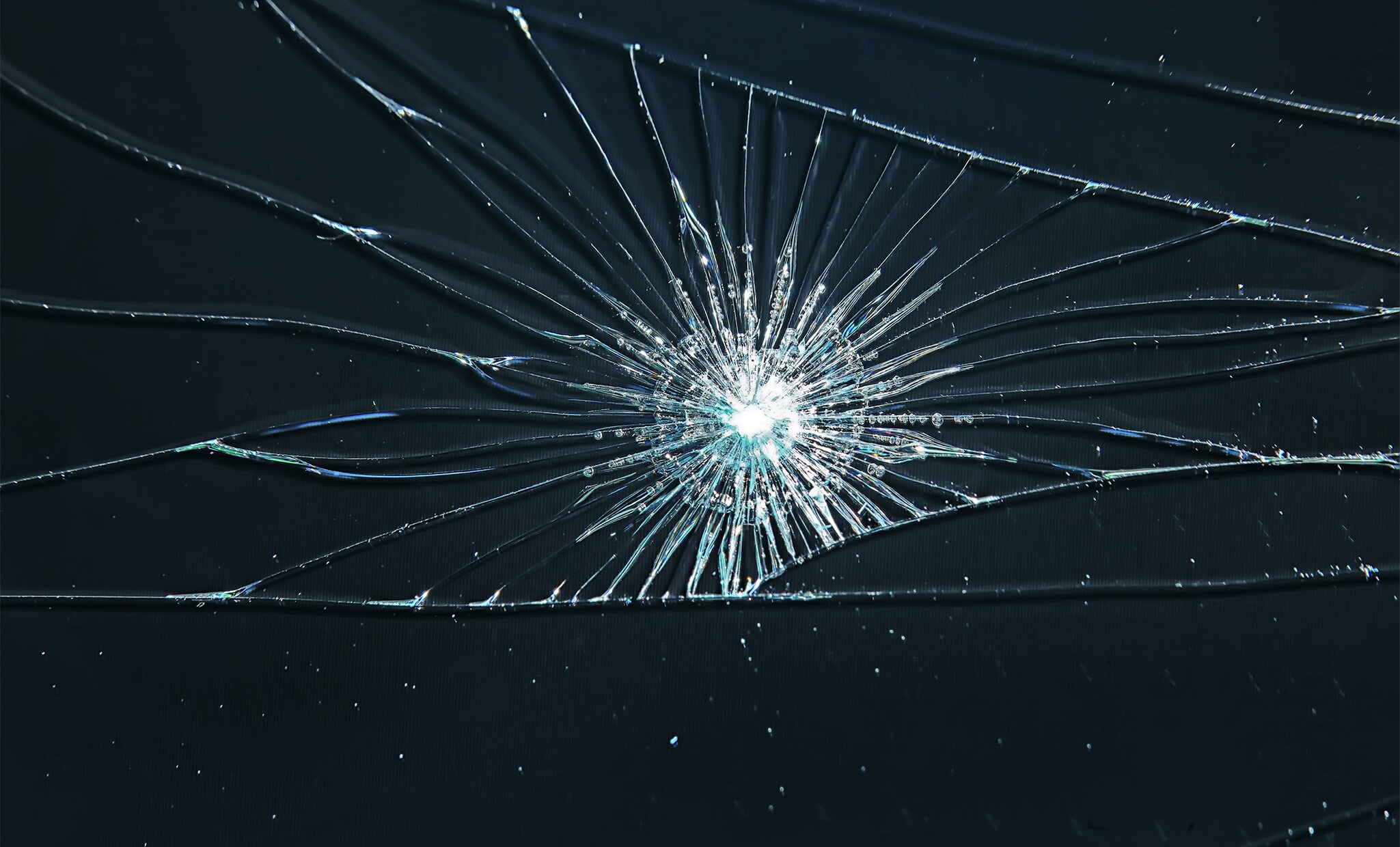 Why You Shouldn’t Drive Around with a Chipped Windshield at Jack Giambalvo Hyundai in York, PA | Broken windshield with more cracks on a navy blue background