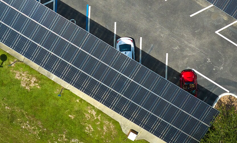 Extend the Life of Your Vehicle at Jack Giambalvo Hyundai in York, PA | Aerial view of a parking lot with solar panels as shade for the white and red car to cool down