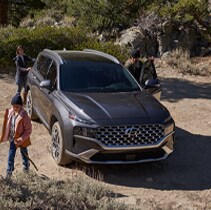 Model Features of the 2022 Hyundai Santa Fe at Jack Giambalvo Hyundai | Santa Fe parked while family climbs mountain