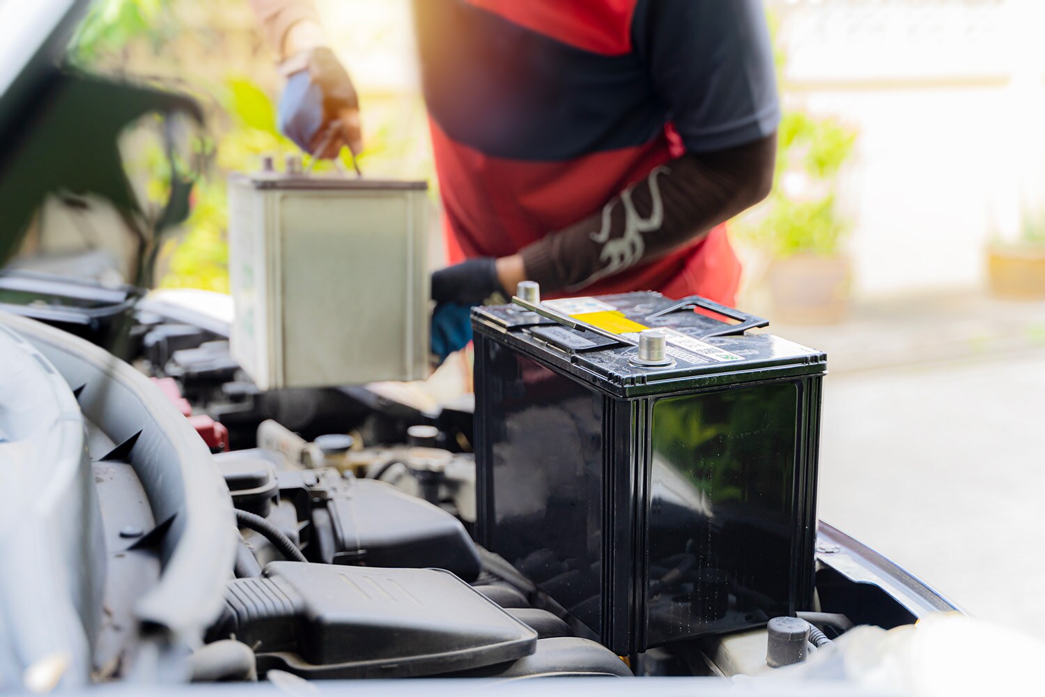 Everything You Need to Know about Your Car Battery at Jack Giambalvo Hyundai | Man taking out old battery to put new one in