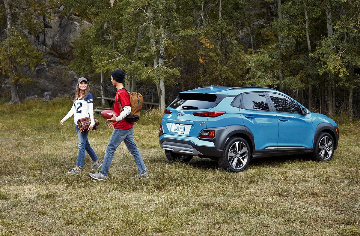 Jack Giambalvo Hyundai is a Hyundai Dealership in York near Lancaster, PA | Young man and woman walking away from 2020 Hyundai Kona parked by the woods