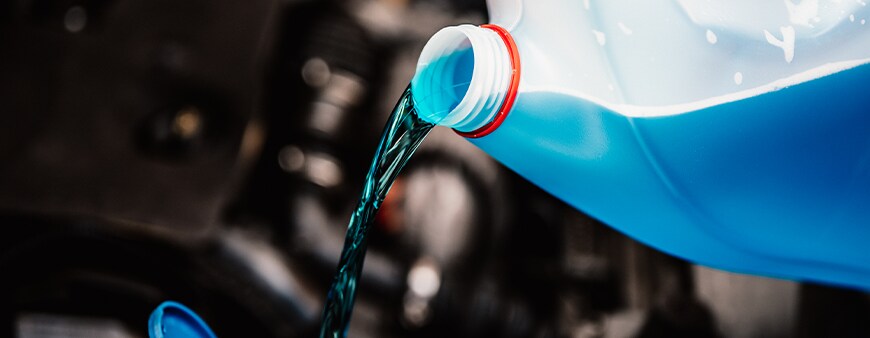 How to prepare your Hyundai for the winter season in York, PA at Jack Giambalvo Hyundai | Blue windshield washer fluid is being poured into reservoir