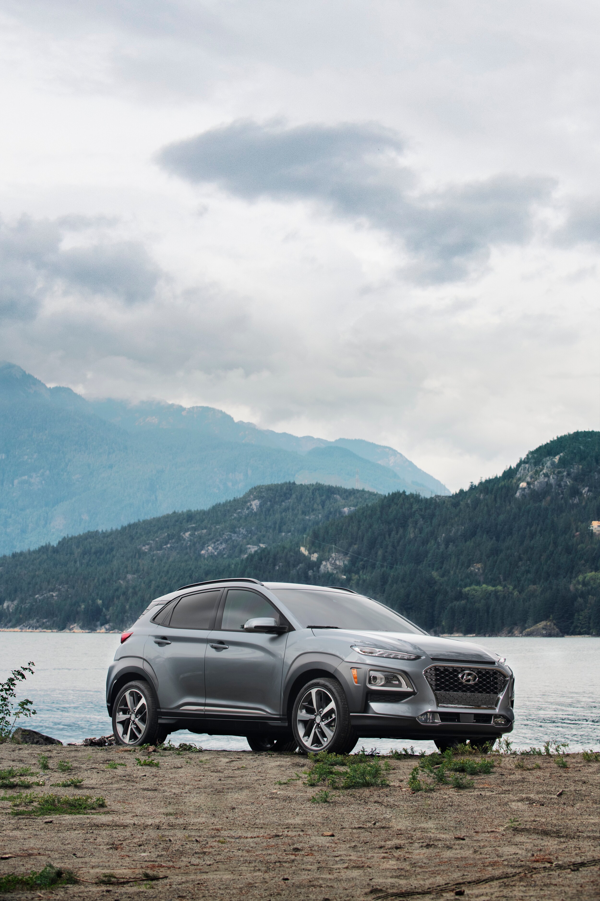 Jack Giambalvo Hyundai is a Hyundai Dealership in York near Manchester, PA | 2020 Hyundai Kona parked by lake with mountains in distance