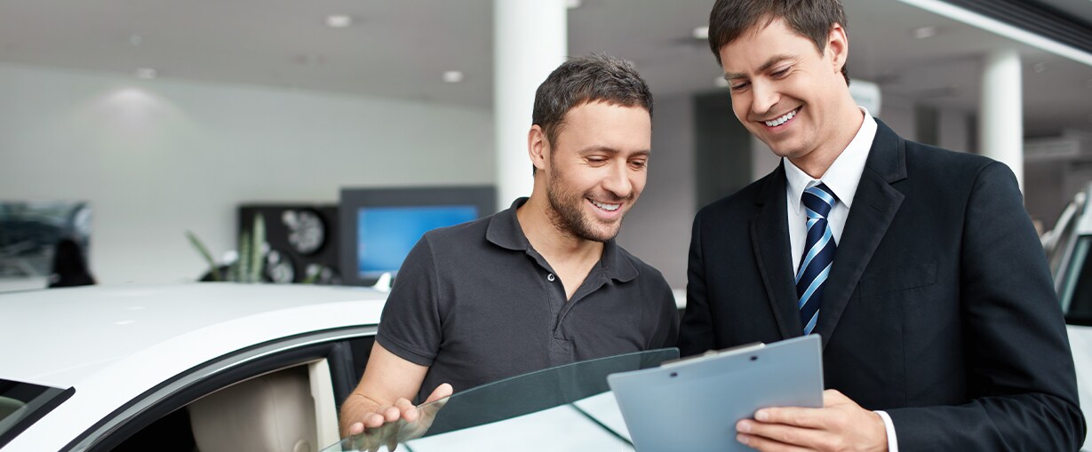 How to Prepare to Trade in Your Car | Jack Giambalvo Hyundai in York, PA | Sales person showing customer the value of their car on a clipboard