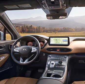 The 2022 Hyundai Tucson vs. The 2022 Hyundai Santa Fe at Jack Giambalvo Hyundai | Santa Fe front interior view overlooking feild