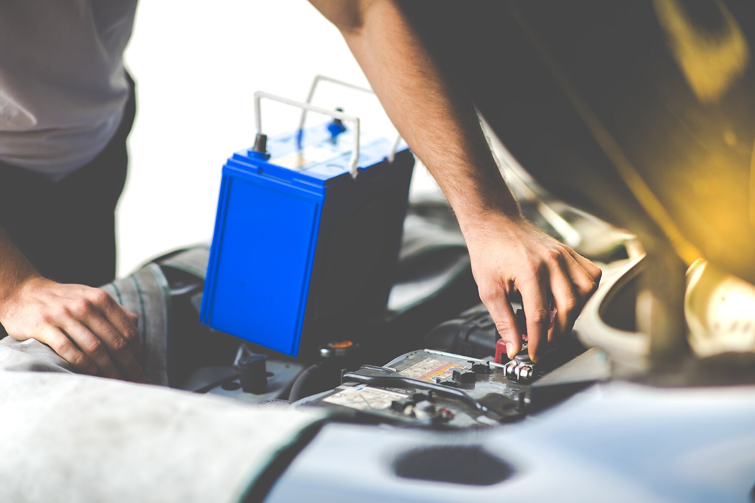 Everything You Need to Know about Your Car Battery at Jack Giambalvo Hyundai | Man reaplacing car battery with new one