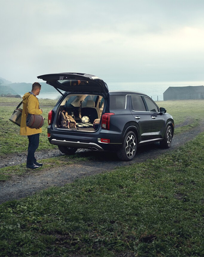 Best MPG At Jack Giambalvo Hyundai in York, PA | Man in yellow jacket is packing the trunk of his car with his personal belongings