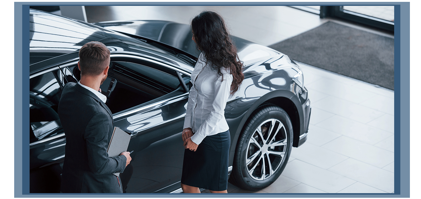 Things to Bring with you to Purchase a Car at Jack Giambalvo Hyundai in York, PA | Sales person in black suit showing the customer a new car in the color dark grey