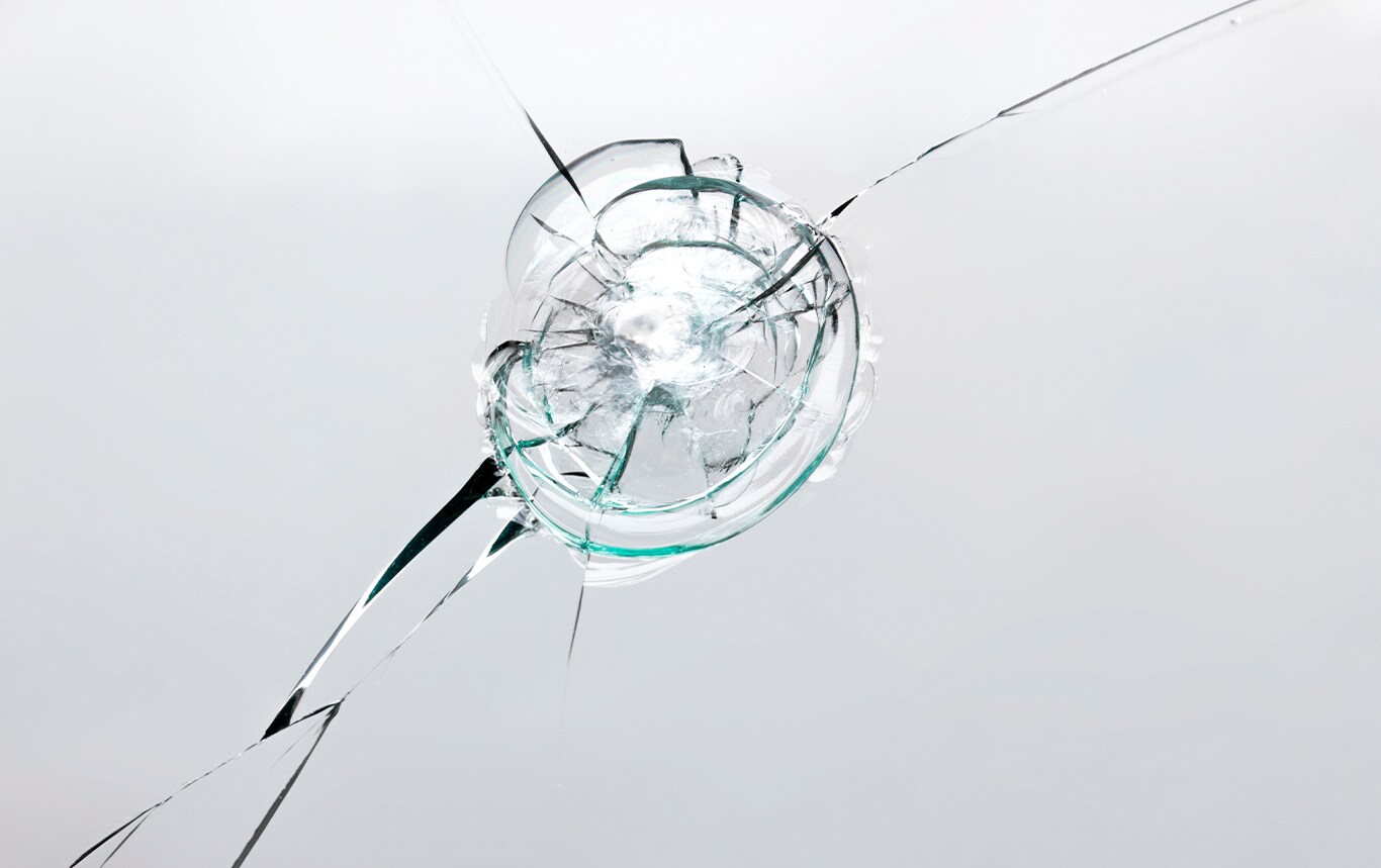 Why You Shouldn’t Drive Around with a Chipped Windshield at Jack Giambalvo Hyundai in York, PA | Chipped windshield with cracks spreading around on a grey background