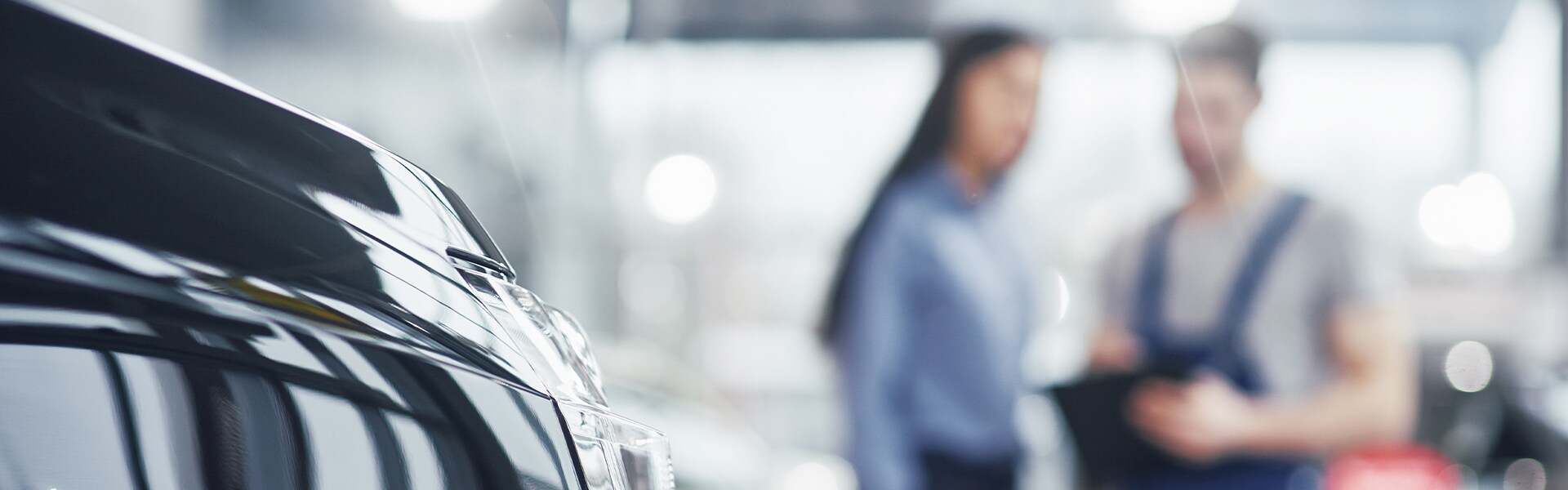 Jack Giambalvo Hyundai is a Hyundai Dealership in York near Dover, PA | A selective focus shot of a sales representative and a mechanic speaking at a dealership