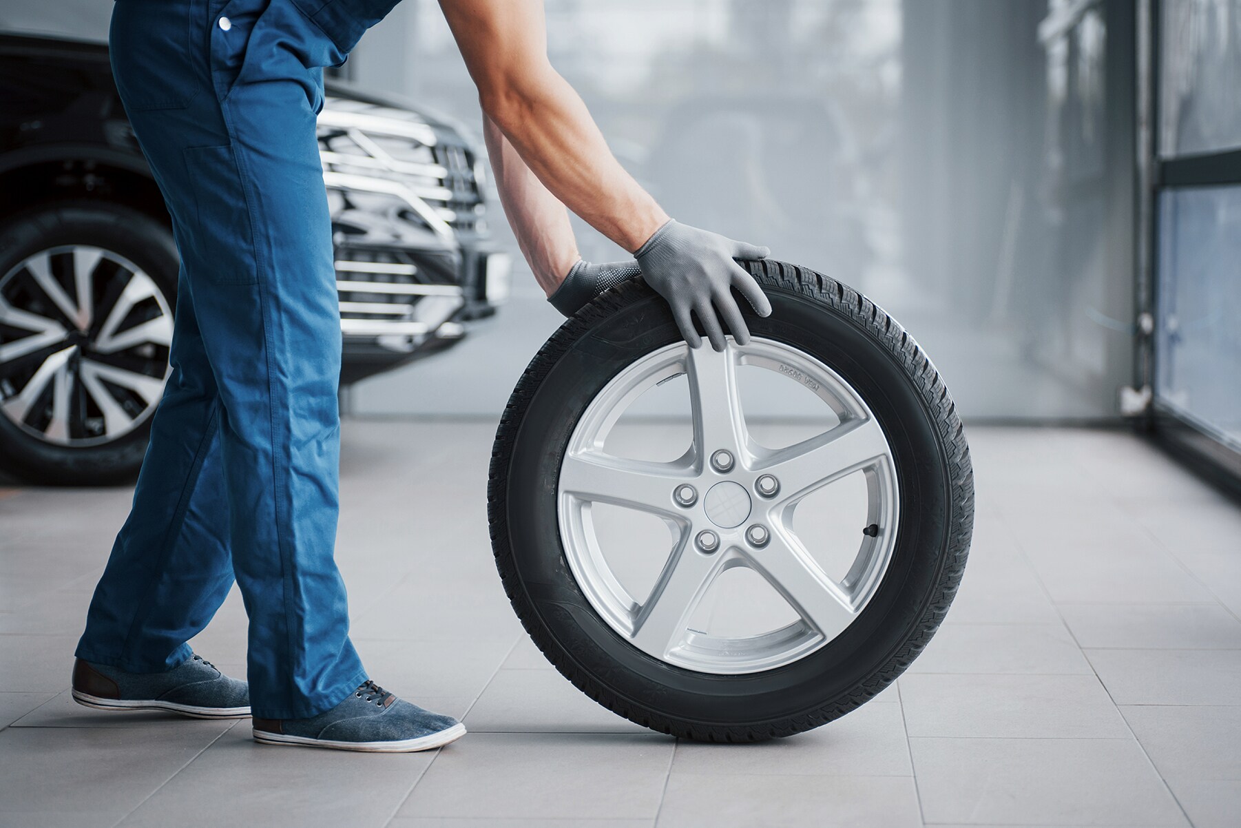 What different tire options are available at Jack Giambalvo Hyundai in York | Service Technician handling brand new tire and wheel