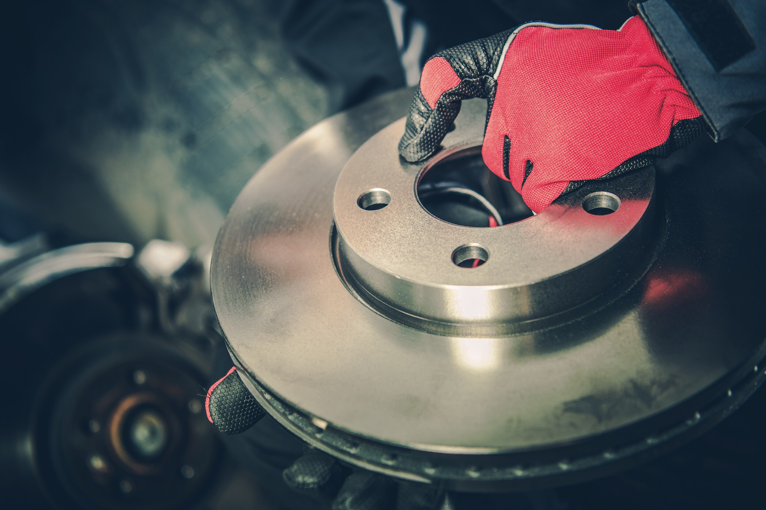 Jack Giambalvo Hyundai is a Hyundai Dealership in York near Wrightsville, PA | Closeup of mechanic holding new brake disc