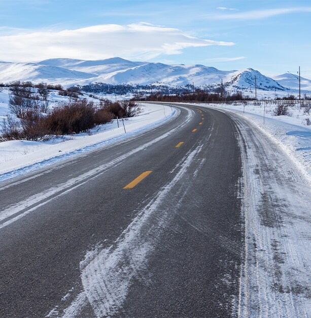 How to prepare your Hyundai for the winter season in York, PA at Jack Giambalvo Hyundai | Open road with some snow on it with mountains in the background