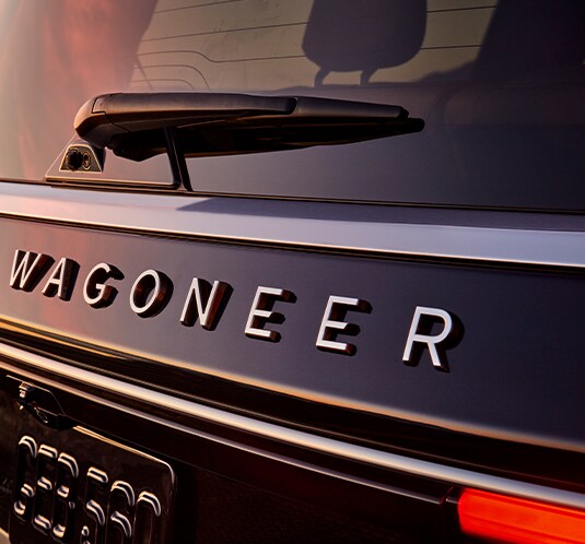 Performance features of the 2022 Wagoneer at Stetler Dodge, Chrysler, Jeep, and Ram of York | Close up shot of the Wagoneer name badge shot at sunset