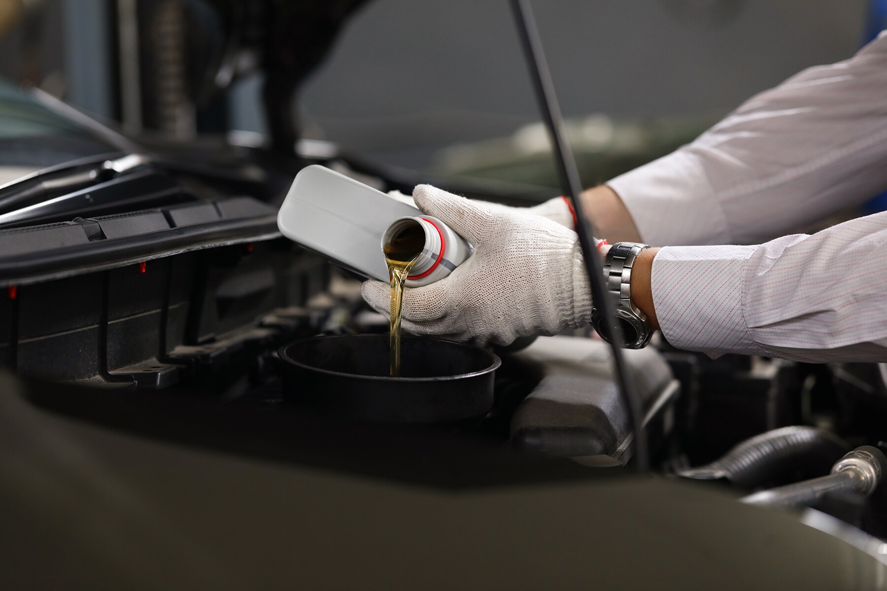 Who makes the best synthetic oil at Jack Giambalvo Mazda in York, PA | Mazda mechanic filling fresh oil into vehicle