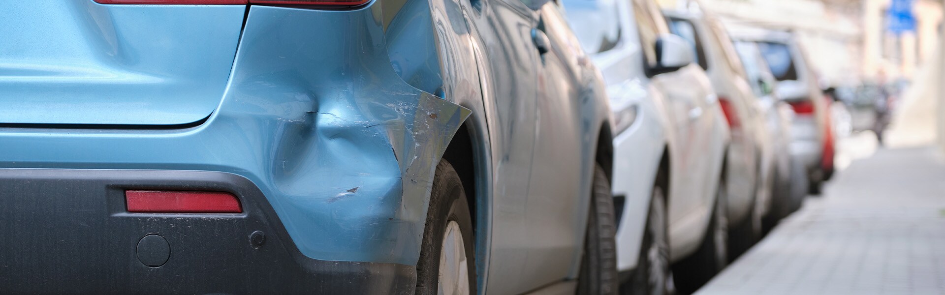 What is Paintless Dent Repair? | Jack Giambalvo Mazda | Car with Bumper Dent Street Parked in City