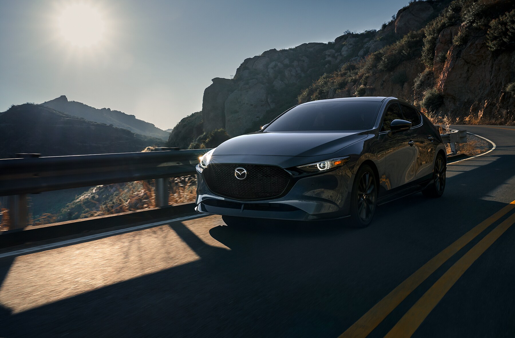 Can I trade in my leased vehicle at Jack Giambalvo Mazda in York | 2021 Mazda3 driving on mountain road
