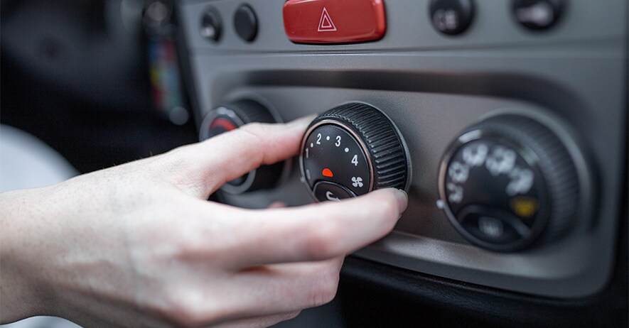 How to Get Your Car Summer Ready at Jack Giambalvo Mazda in York, PA | Person turning the knob to change the climate temperature in his car