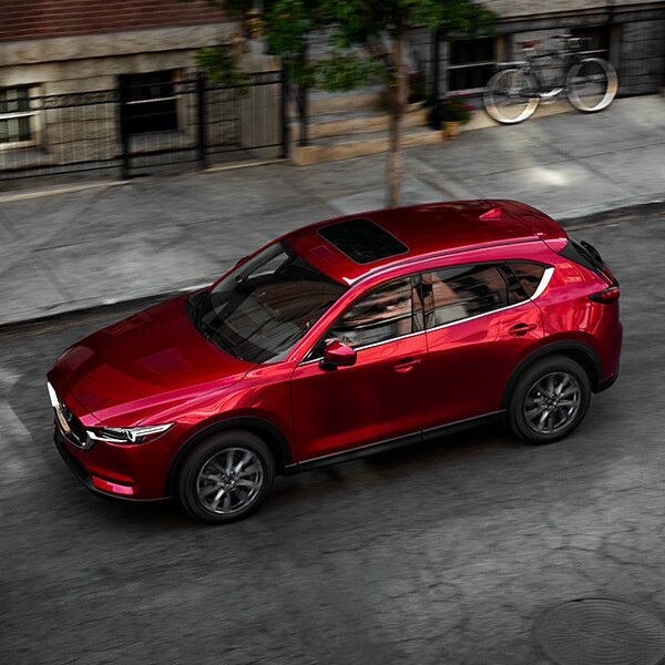 The 2022 Mazda CX-5 vs. The 2022 Mazda CX-30 at Jack Giambalvo Mazda | Aerial View of Red 2022 Mazda CX-5 Street Parked in City