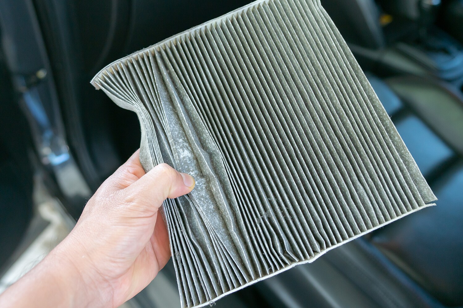 Cabin air filter replacement at Jack Giambalvo Mazda of York | Hand holding dirty cabin air filter