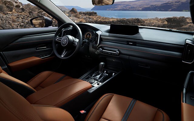 Model Features of the All-New 2023 Mazda CX-50 at Jack Giambalvo Mazda | Interior of 2023 Mazda CX-50 Passenger Seat, Driver Seat, Center Console, and Steering Wheel