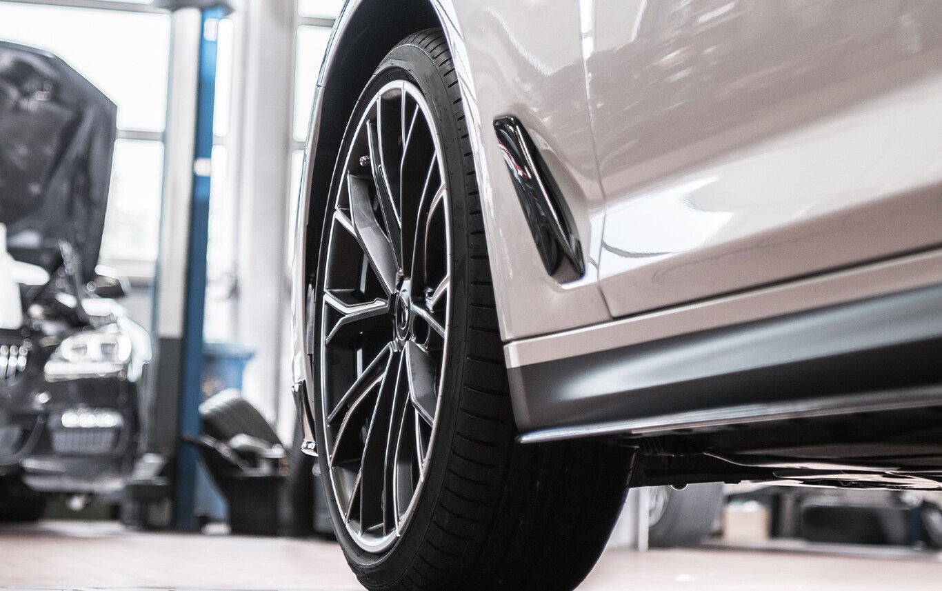 What is Tire and Rim Protection? | Jack Giambalvo Mazda | Close up of grey car's rear wheel while parked in a garage