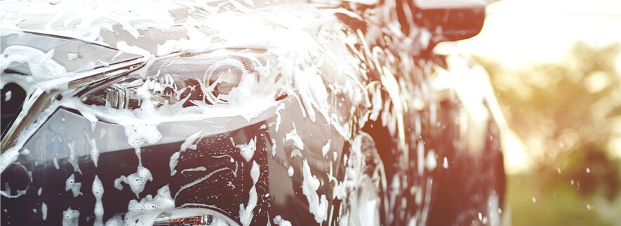 How to Get Your Car Summer Ready at Jack Giambalvo Mazda in York, PA | Black mazda covered in soap and water for a car wash on a nice sunny day
